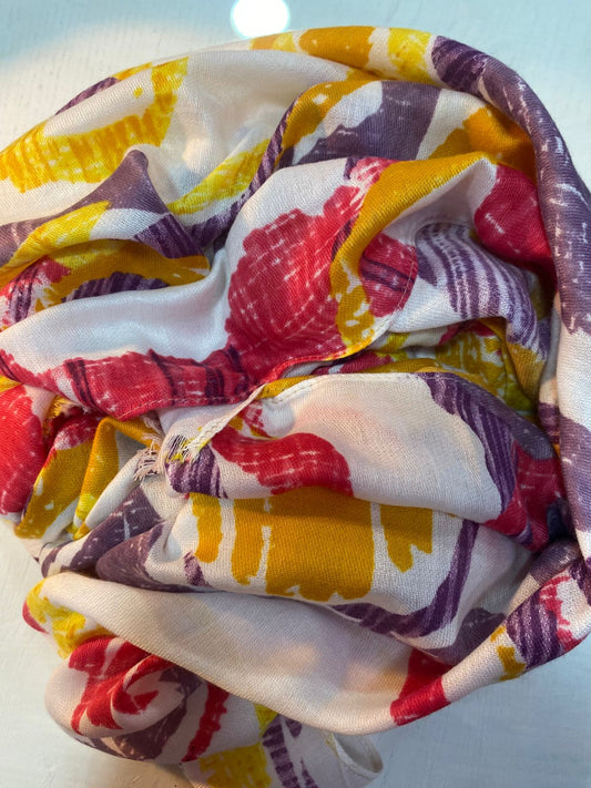 Pañuelo en tonos rosas, morados y amarillos