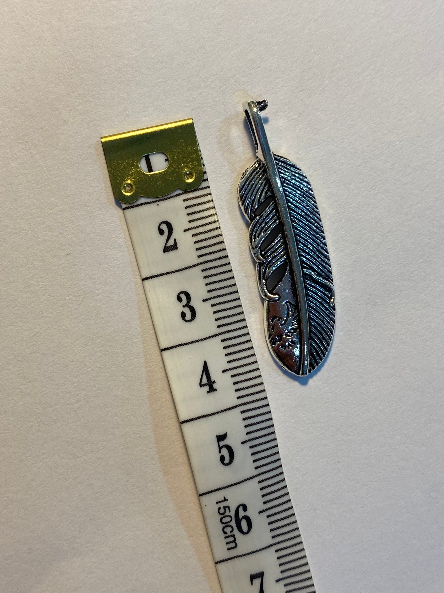 Dijes de pluma plateados 4 cm de largo